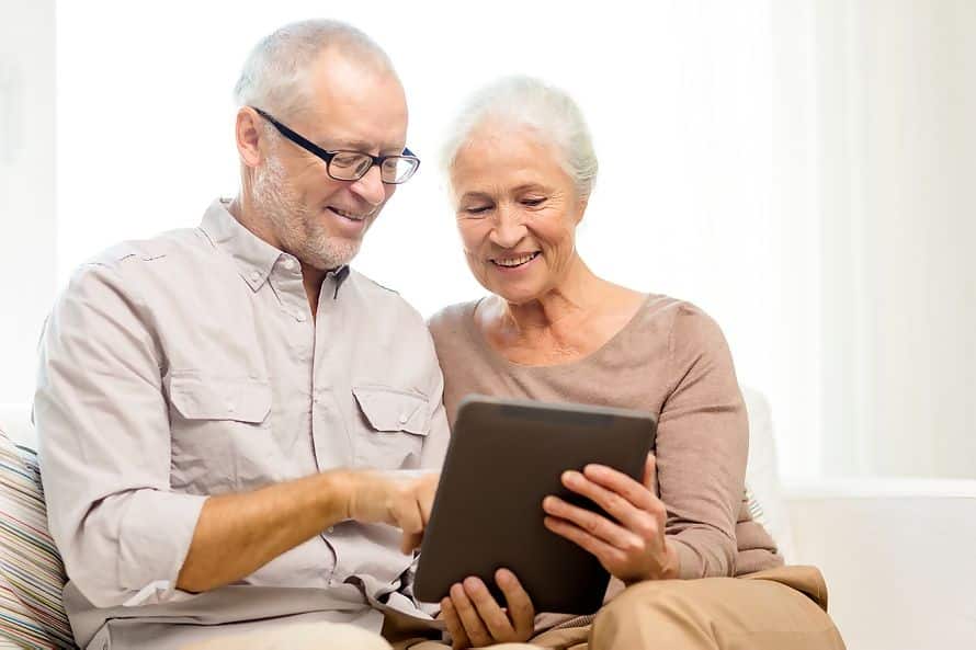 Man and Woman looking at a tablet device